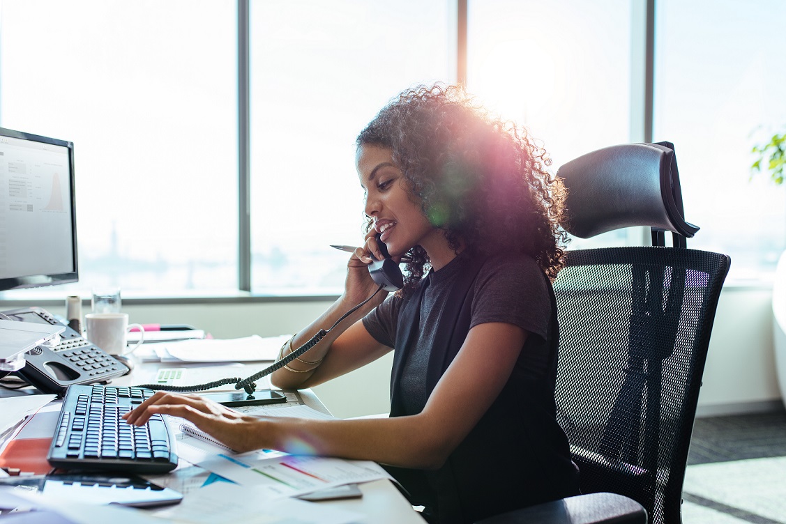 Businesswoman working at her desk in office.