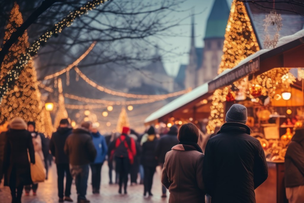 Christmas market. People walking in street Christmas market in evening time.