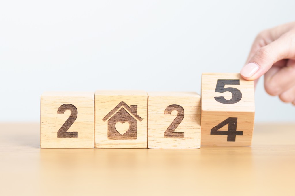 2024 end year to Happy New Year 2025 with Home and Heart block. Property investment, House Mortgage, Real Estate tax, homeless, donation, Financial and happy family concepts