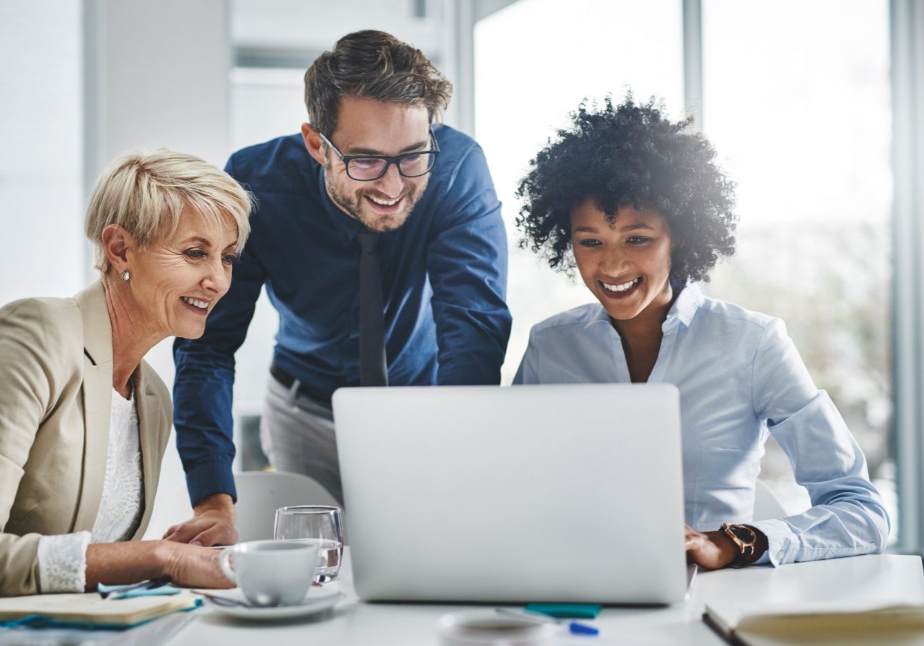 Shot of a group of businesspeople working together on a laptop.
